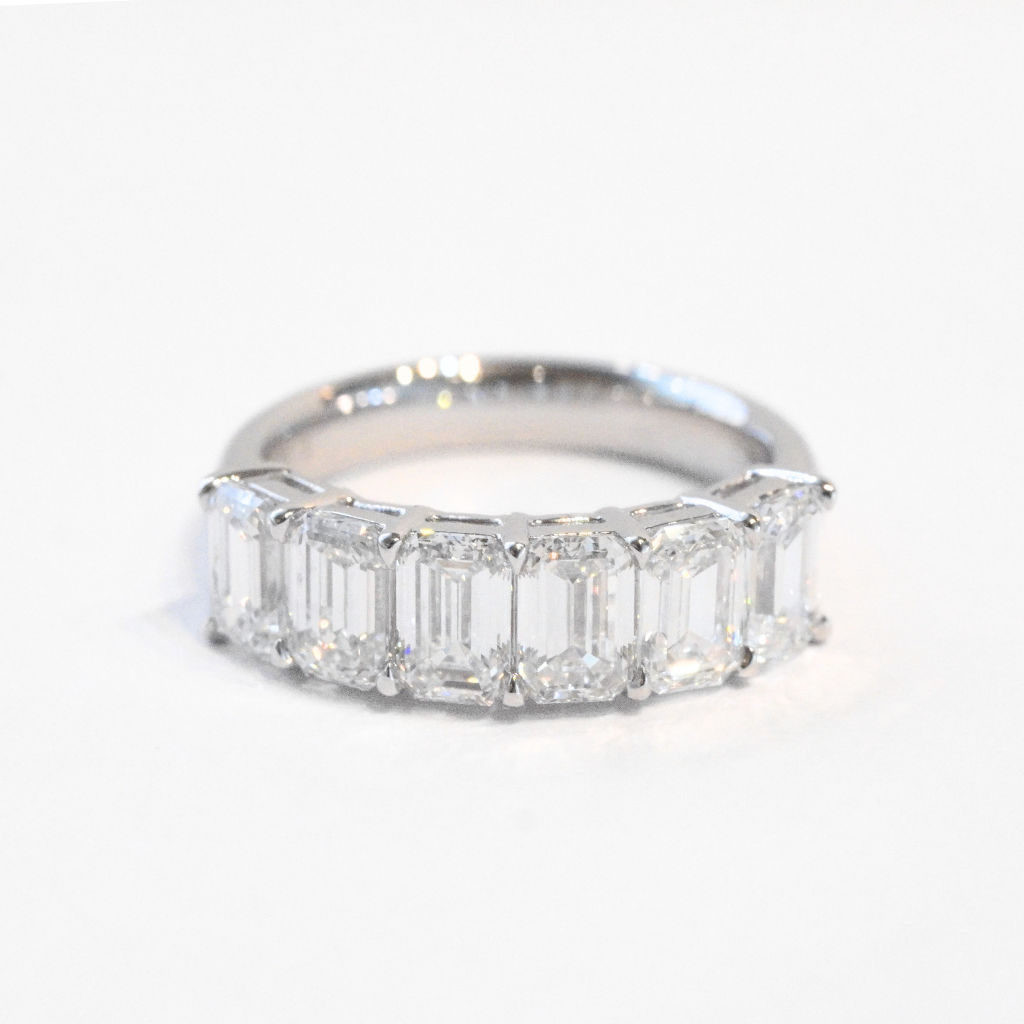 Emerald cut diamond half eternity ring